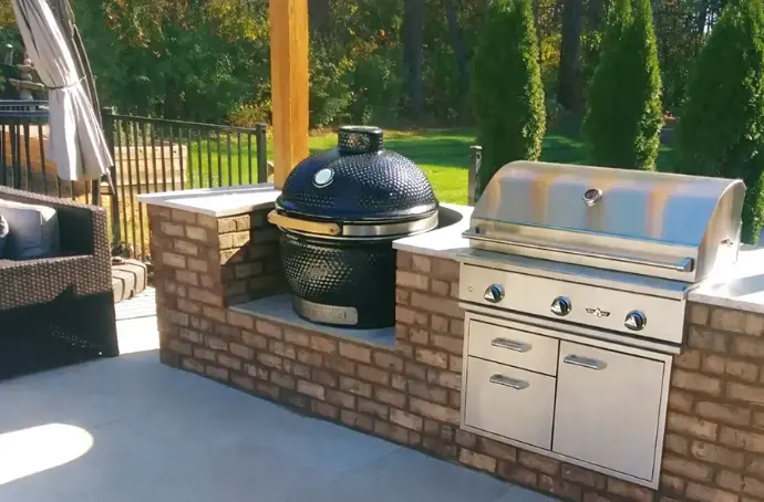 Big Green Egg ceramic smoker integrated into stone kitchen island