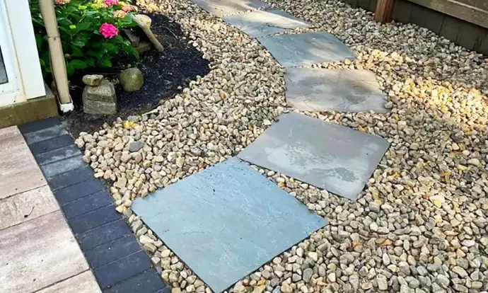 Delaware river rock installation for low maintenance landscape